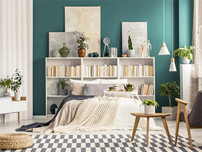 Green Painted Bedroom Wall with Book Case as a Bedhead